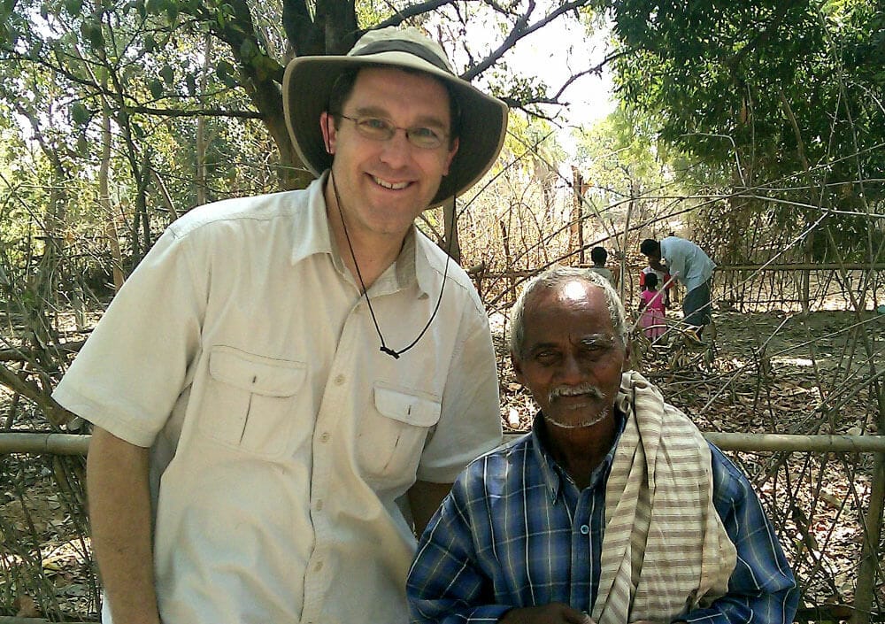 Posing with old man under tree