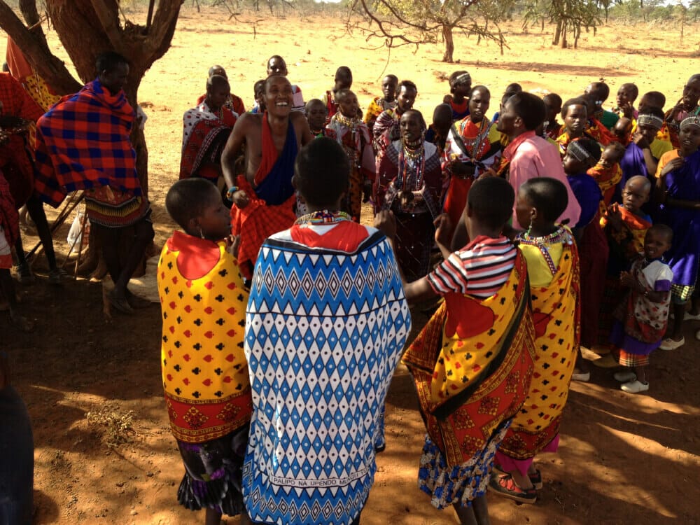 Women gatherd in coloful dress to hear stories